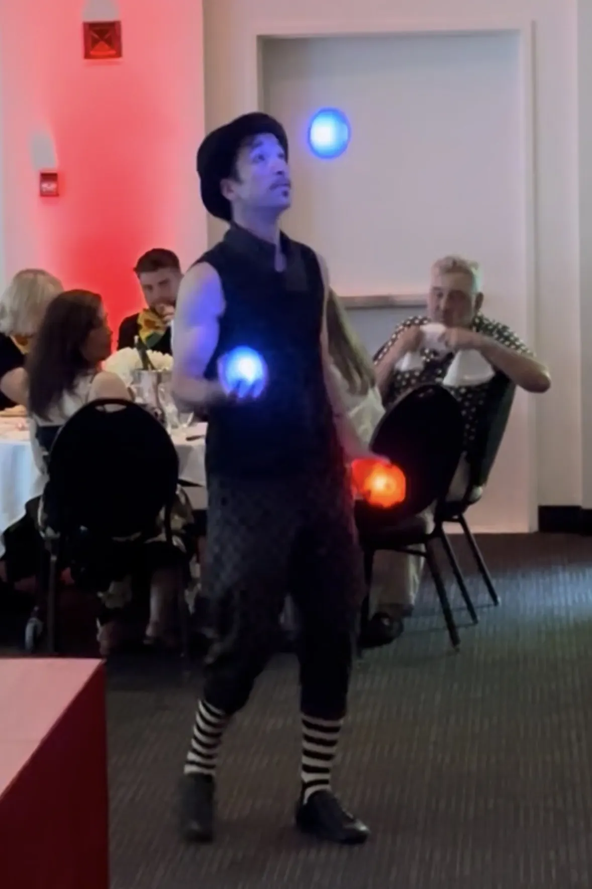 Jongleur aux balles lumineuses parmi les invités